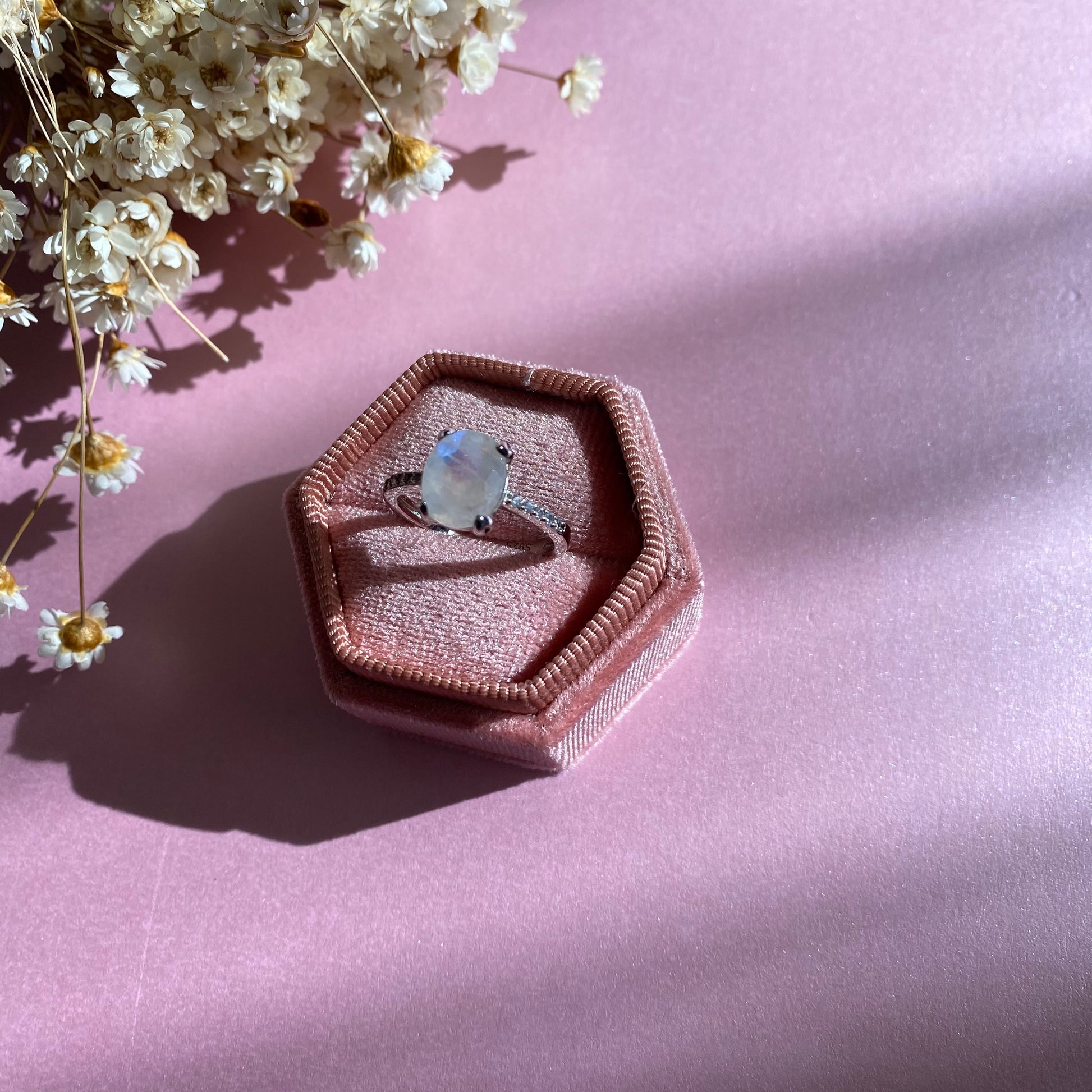 Moonstone Ring with CZ Pave Setting, 925 Sterling Silver, sitting on a pink velvet ring box